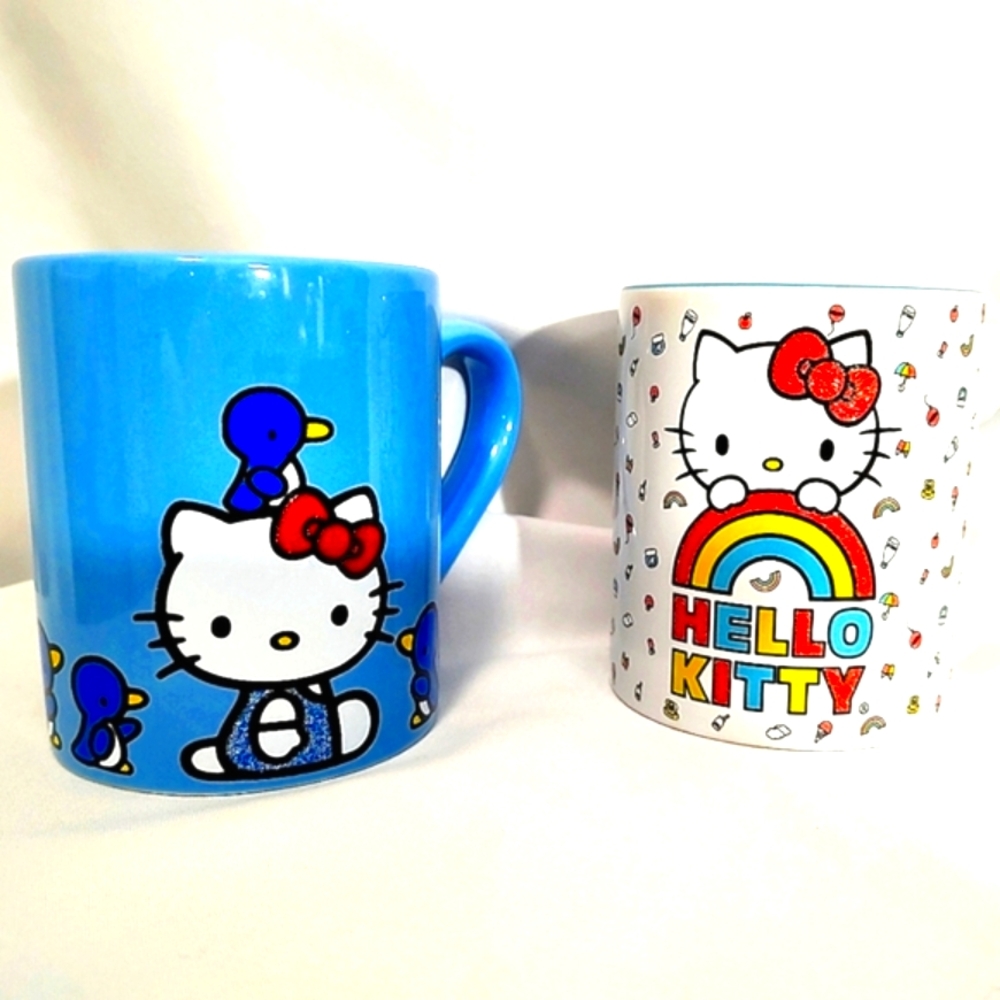 2 Glitter mugs one Penguins & Rainbows. Lot of 2 Hello Kitty NWOT